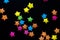 Multicolored origami paper star on black backdround