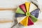 Multicolored pancakes lined on plate in a circle and decorated kiwis