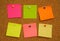 Multicolored paper notes on cork board