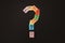 Multicolored paper with QUESTION MARK isolated on black background