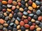 Multicolored pebbles, marble stones seamless pattern isolated on black background