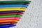 A multicolored pen on a white jigsaw background, color drawing device