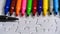 A multicolored pen on a white jigsaw background, color drawing device