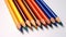 Multicolored pencils, drawing tools and hobbies. Solid color background