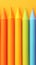 Multicolored pens form LGBT flag against vibrant rainbow backdrop