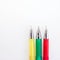 Multicolored pens on white background.