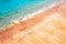 Multicolored pink sand and blue water on a deserted red beach. Tropical sand background.