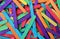 Multicolored popsicle sticks in bulk in shades of purple red light blue yellow orange green for desktop background c