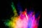 Multicolored powder explosion on black background.Abstract colorful dust particles textured background