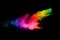 Multicolored powder explosion on black background.Color dust splash cloud on dark background.Launched colorful particles