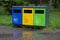 Multicolored recycling bins in the park. Outdoor garbage containers for plastic, paper, glass. Sustainable lifestyle concept