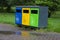 Multicolored recycling bins in the park. Outdoor garbage containers for plastic, paper, glass. Sustainable lifestyle concept