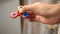 Multicolored, red-yellow-blue hand spinner, or fidgeting spinner, rotating on man`s hand.