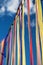 Multicolored ribbons or garlands flutter in the wind on a summer sunny day with a blue sky with clouds.The concept of a festive