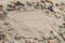 Multicolored river pebbles stones randomly lie on the sand next to the sea. Macro photography. Close-up background concept, copy