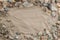 Multicolored river pebbles stones randomly lie on the sand next to the sea. Macro photography. Close-up background concept, copy