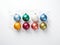 Multicolored round festive Christmas balls on white background