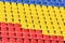 Multicolored rows of seats in a football stadium. Abstract background of empty seats