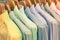Multicolored shirts hanging on shop rack at weekly flea market