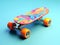 Multicolored skate board or skating surf board on light blue background, extreme lifestyle and active sports. Colorful cruiser