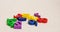 Multicolored small bright children`s numbers for development from zero to nine lie randomly on a white background