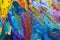 Multicolored small strokes of oil paint in blue, orange, purple shades on canvas, close up. Creative conception of