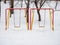 Multicolored snow-covered swing for children