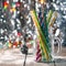 Multicolored spiral straw cocktails in a glass jar Mason on a festive New Year`s background. Sweet table. A table with a drink.