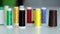 Multicolored spools of sewing thread on a white background