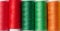 Multicolored spools of sewing threads on a white background, top view