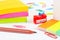 Multicolored stationery supplies on white desktop closeup