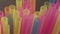 Multicolored straws for drinks, close-up, camera movement, dark background