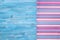 Multicolored striped napkin on blue board