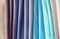 Multicolored swatches of upholstery fabric in blue tones, background