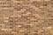 Multicolored tan and brown brick wall background
