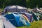 Multicolored tents on music festival campsite at park