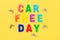 Multicolored text Car Free Day and small bicycles on yellow background. Concept of world car free day on September 22. Top view