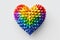 Multicolored three-dimensional heart of geometric shapes on white background