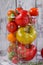Multicolored tomatoes of different sorts in a glass jar