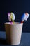 Multicolored toothbrushes in Glass on dark background