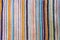 Multicolored vertical bright strips of woven material texture. Copy space background