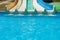 Multicolored water slides with turquoise swimming pool in amusement aqua park outdoors sunny summer vacation day with copy space