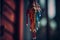 a multicolored wind chime hanging from a tree branch with dripping paint on it\\\'s sides