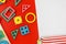 Multicolored wooden blocks on a red background. Trendy puzzle toys. Geometric shapes: square, circle, triangle, rectangle.