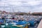 Multicolored wooden boats and speedboats at a stop in Nice. Travel to Cote d`Azur in France