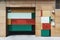 Multicolored wooden facade of a house with two different doors