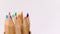 Multicolored wooden pencils rotating on a white background.