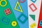 Multicolored wooden toys, blocks on green blue background. Trendy puzzle toys. Geometric shapes: square, circle, triangle,