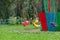 Multicolored yellow and red plastic seats hanging on the chains carousel in the park for entertainment and fun for children and