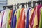 Multicolored youth summer tunic on a hanger. Colorful clothes on hangers for sale in shop. Summer season, assortment in